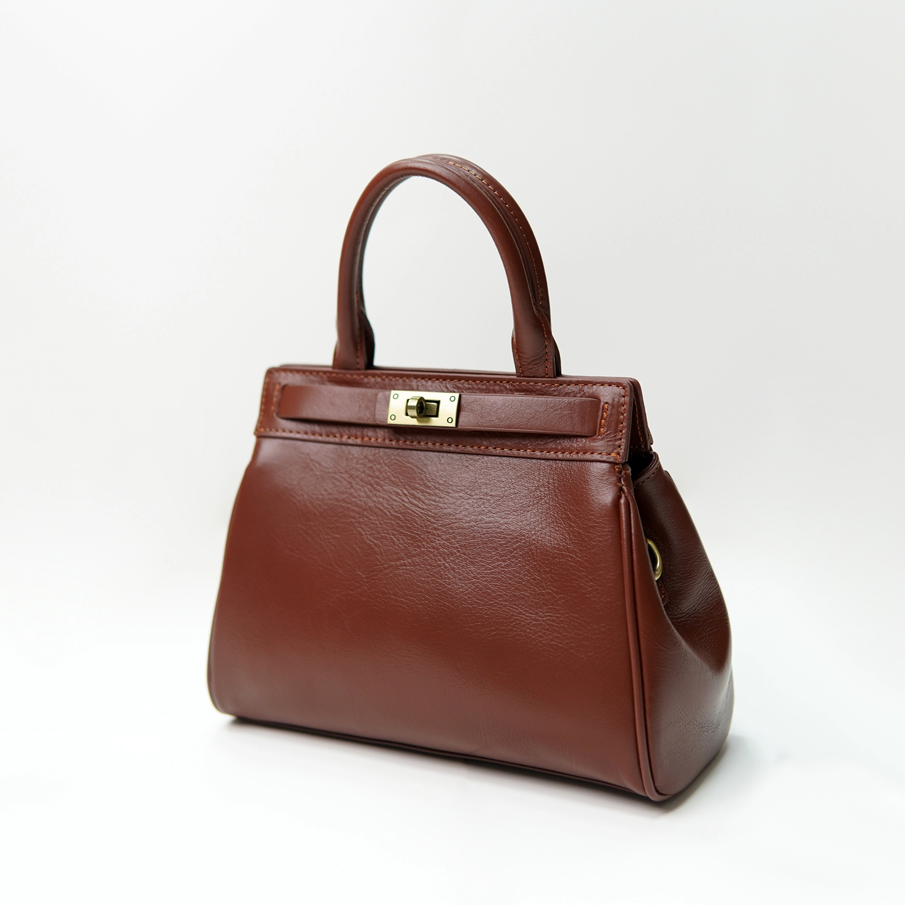 Brown structured handbag sample for custom handbag manufacturing hardware alignment review