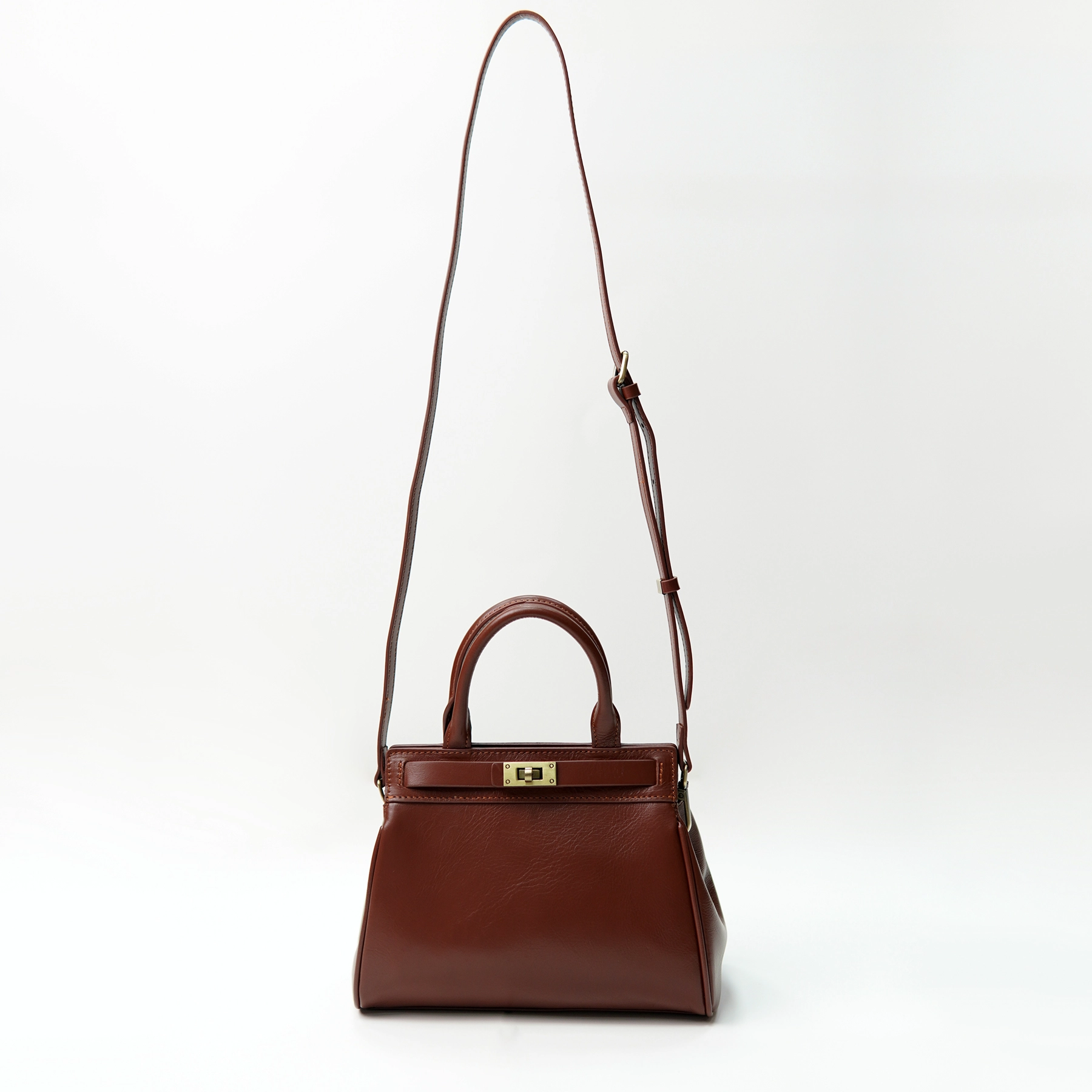 Brown leather handbag sample with adjustable strap for custom handbag manufacturing review