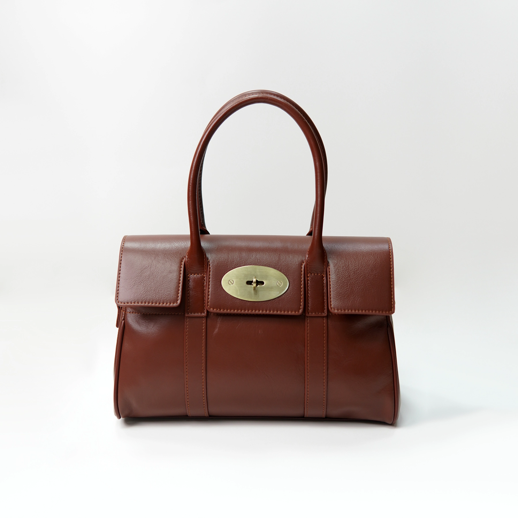 Brown leather top-handle handbag sample for custom handbag manufacturing review
