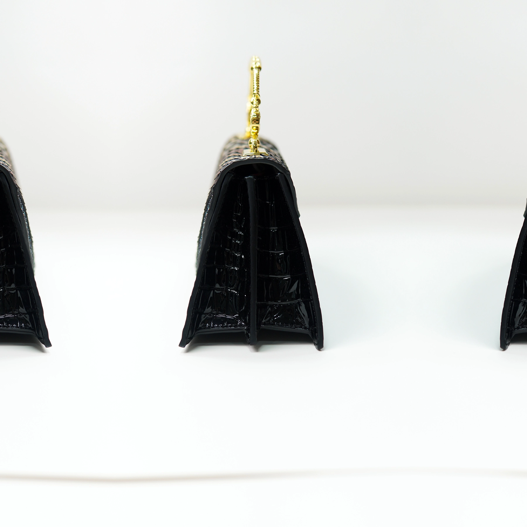 Black structured handbag side profile for custom handbag manufacturing review