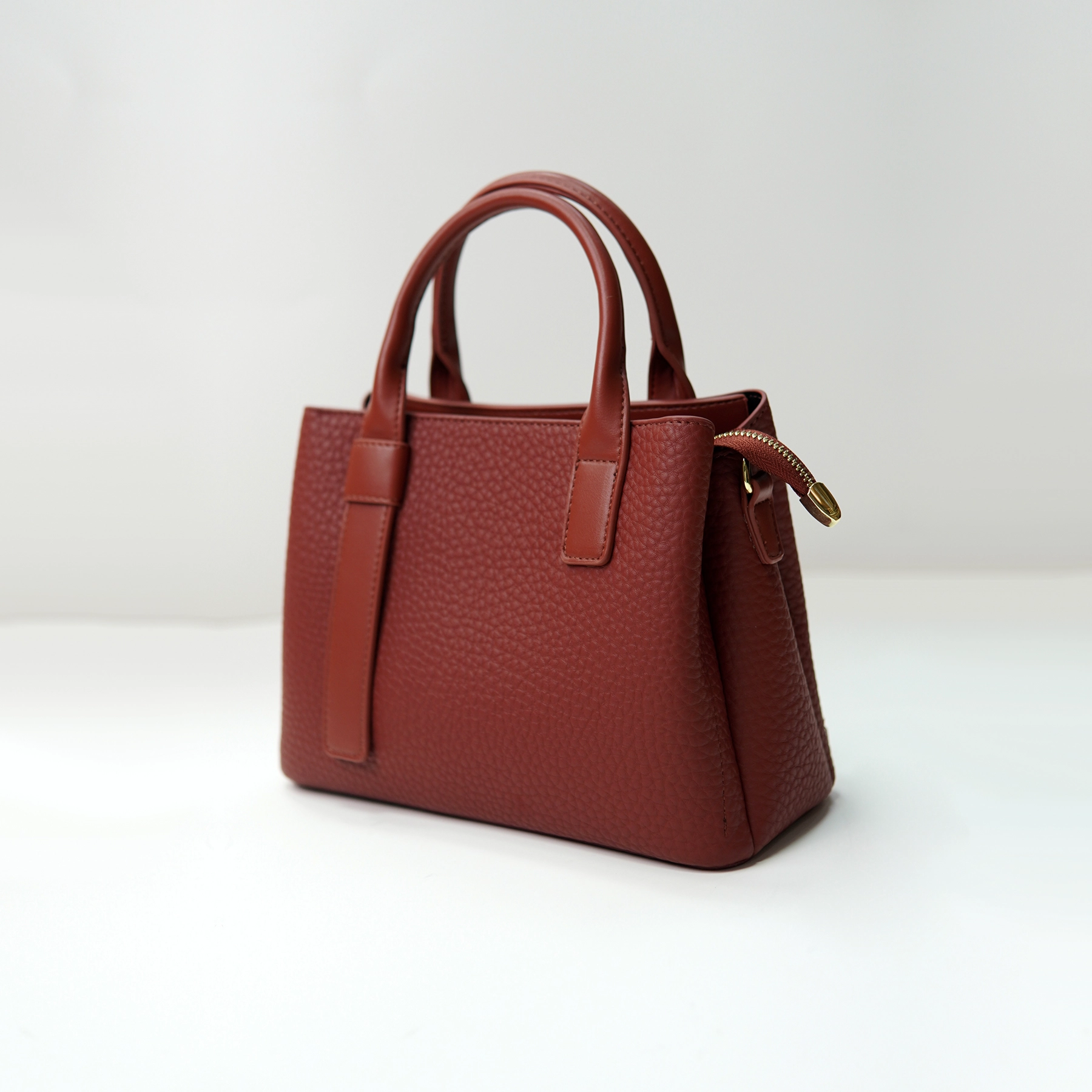 Pebbled leather tote sample for custom handbag manufacturing specification review