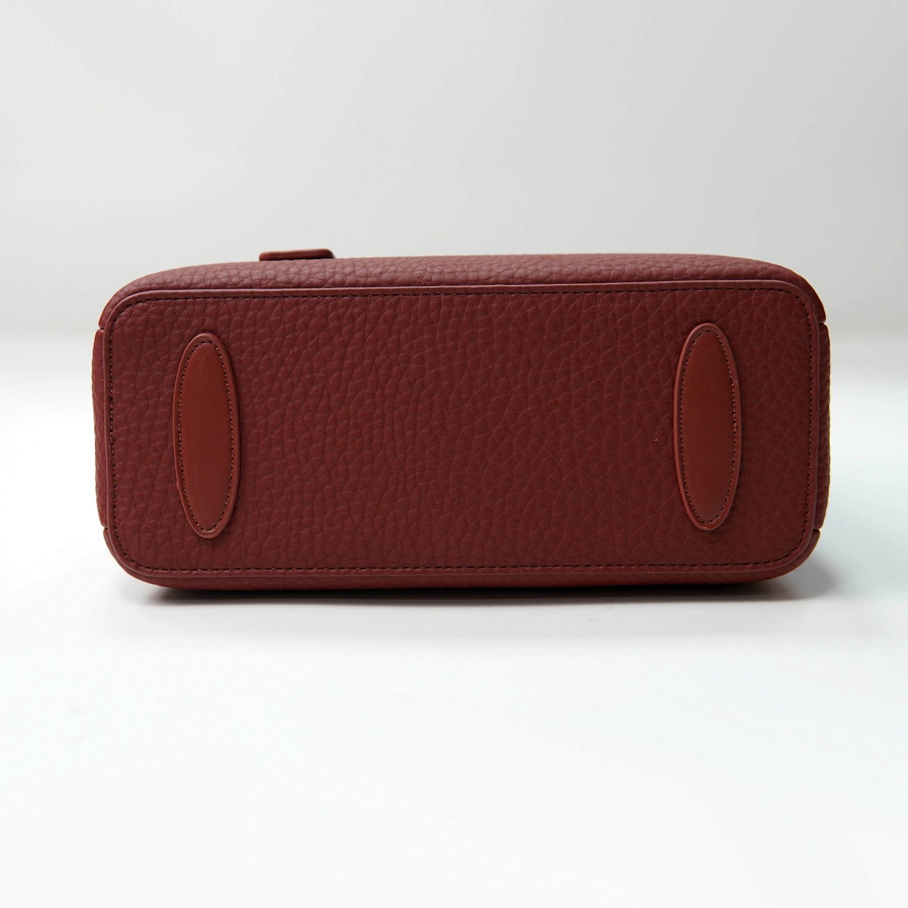 Pebbled leather handbag base panel documented for custom handbag manufacturing review