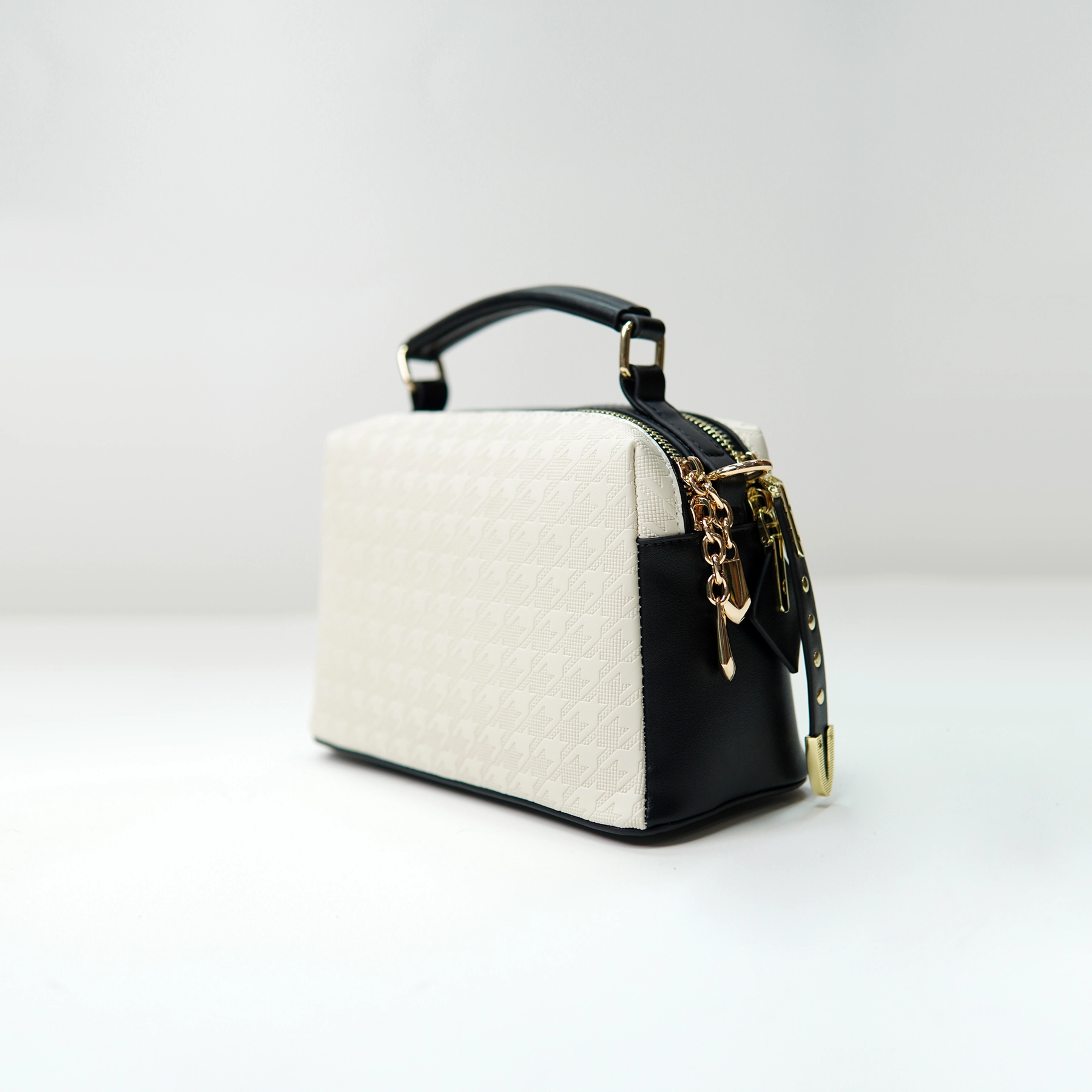 Structured handbag sample with embossed panel for private label handbag production