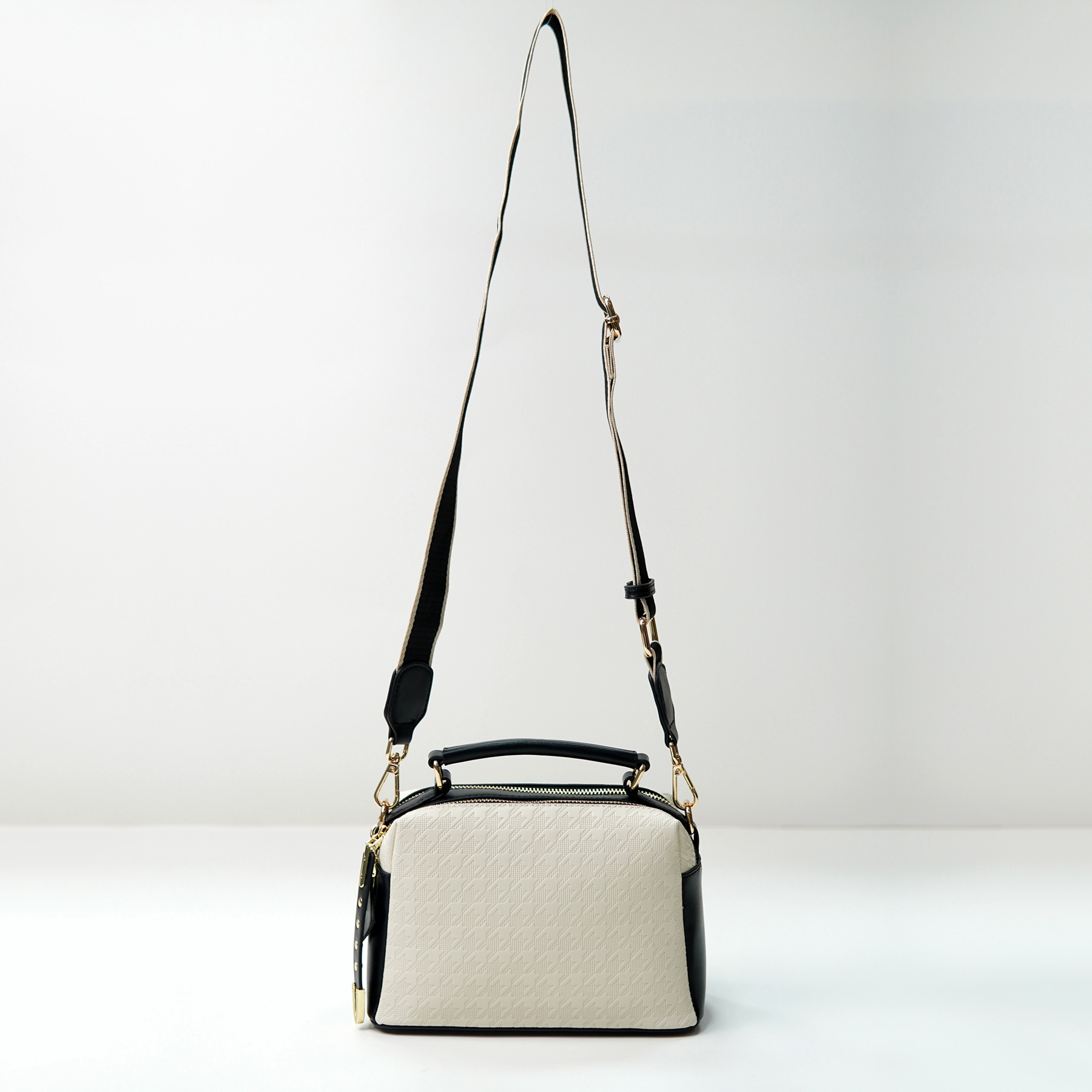 Structured crossbody handbag sample with adjustable strap for custom handbag manufacturing