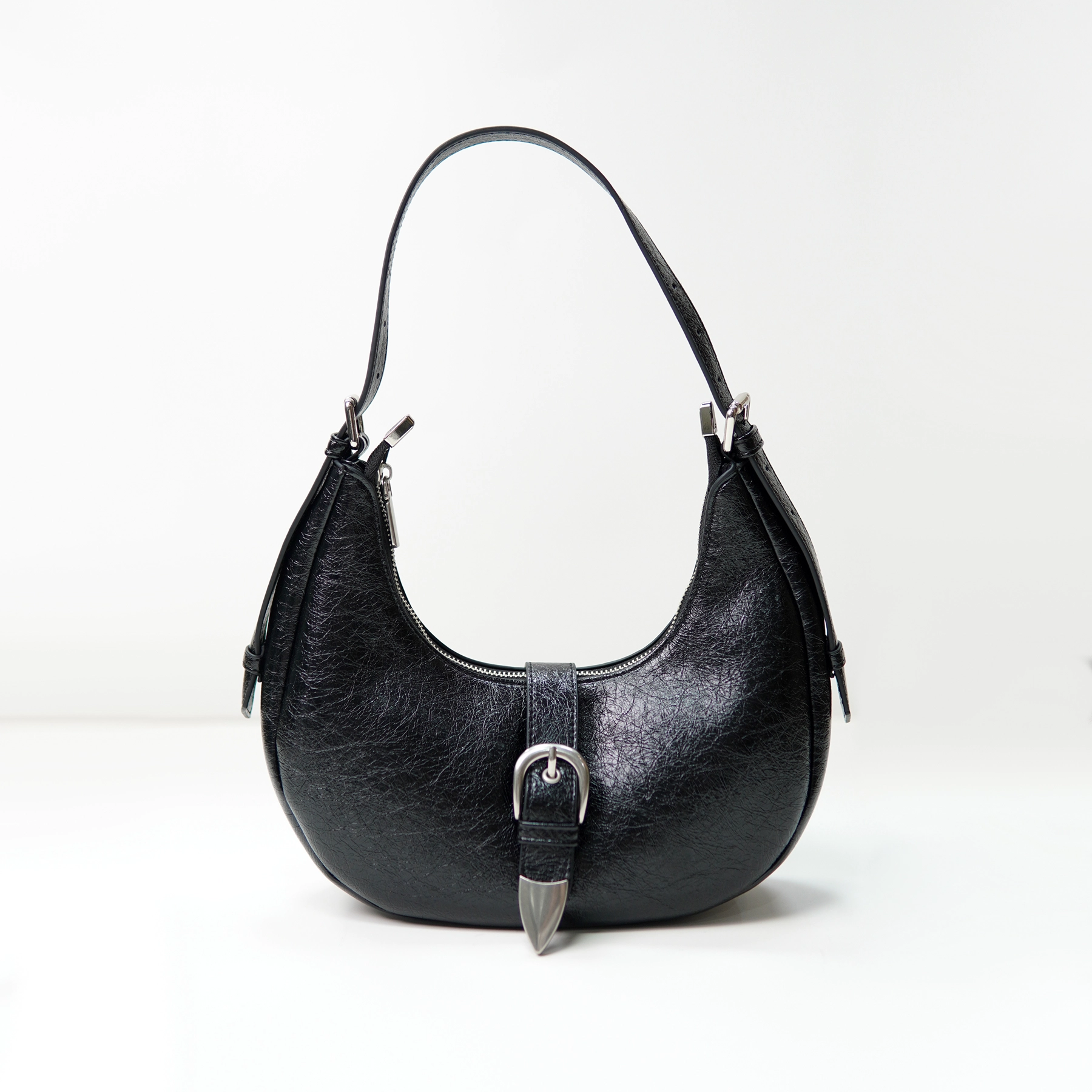 Black crescent shoulder bag sample for custom handbag manufacturing review