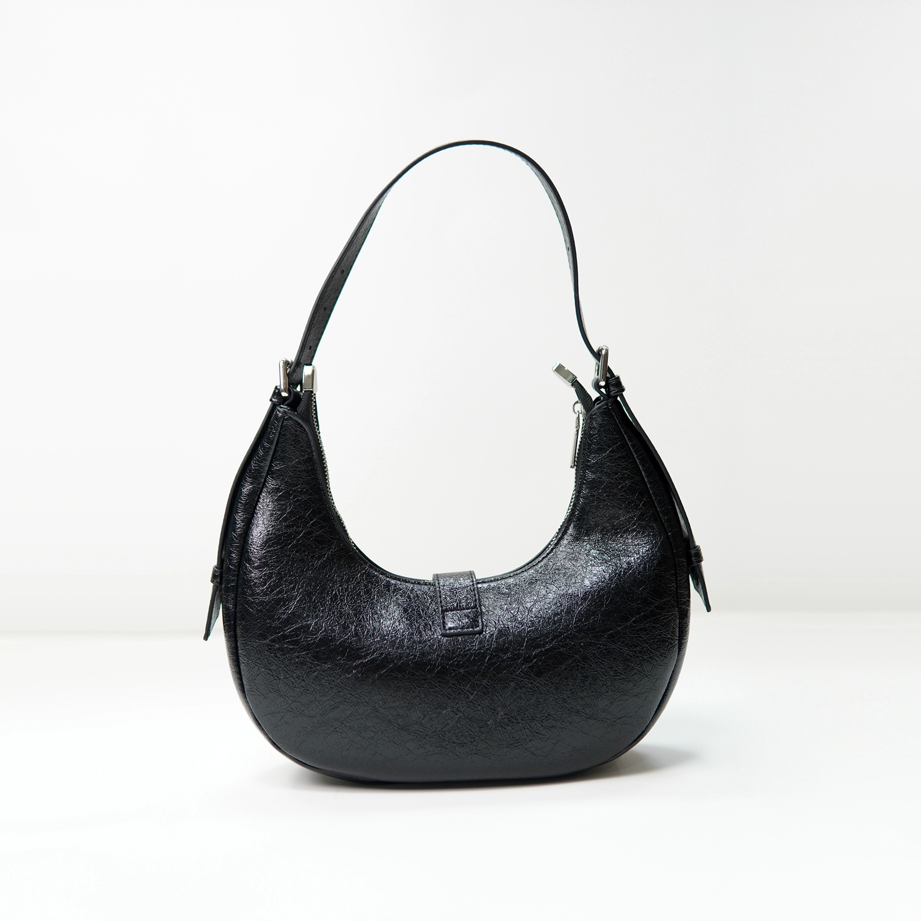 Black crescent shoulder bag sample for custom handbag manufacturing review
