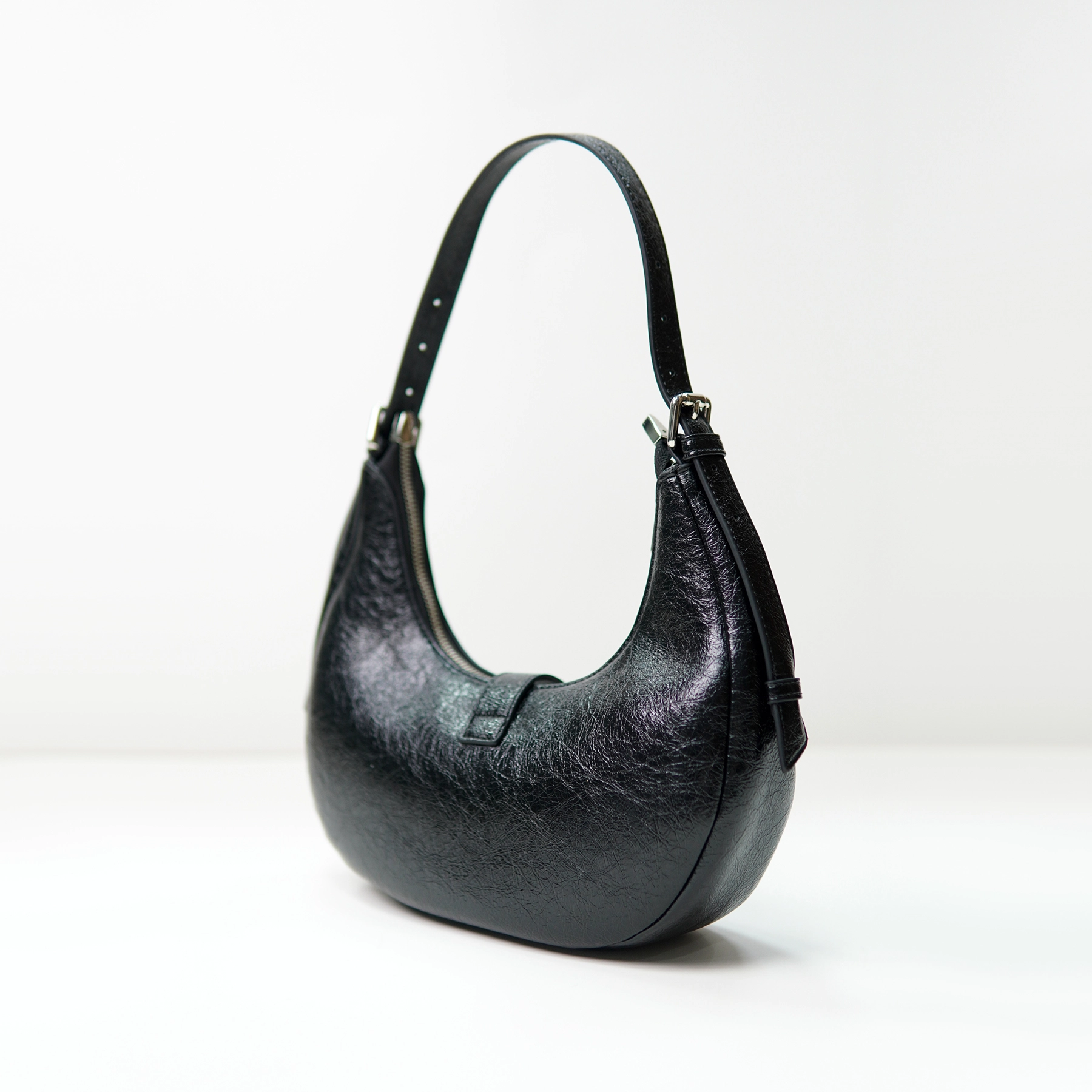 Black crescent shoulder bag sample for custom handbag manufacturing review