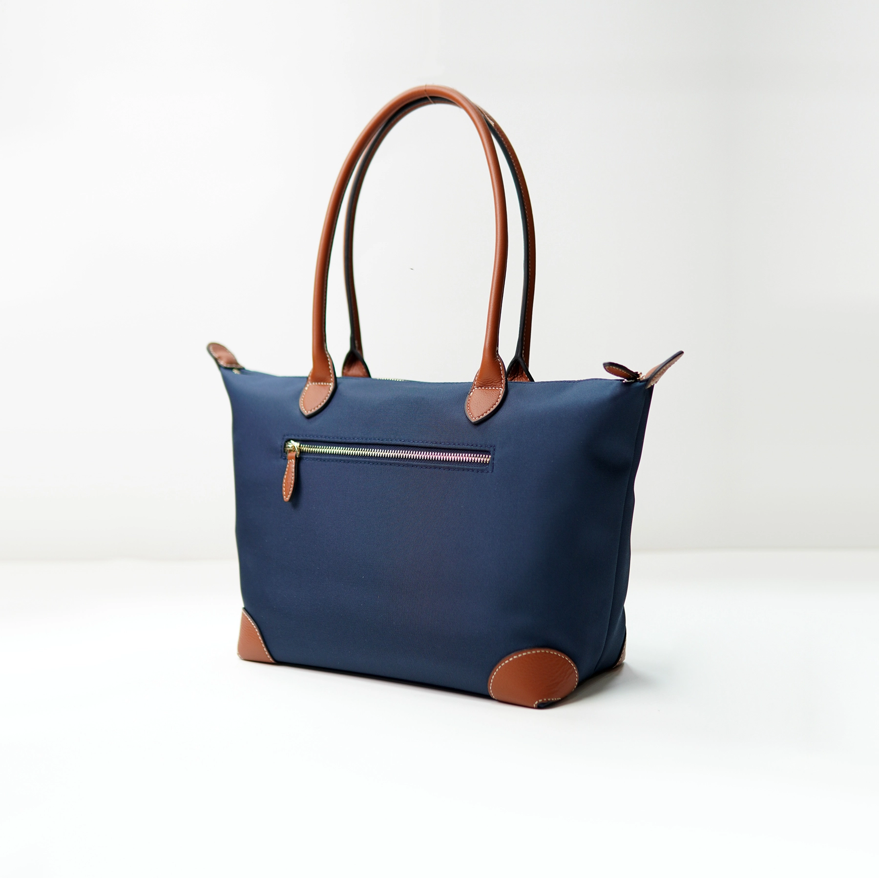 Navy tote bag sample with leather trim for custom handbag manufacturing