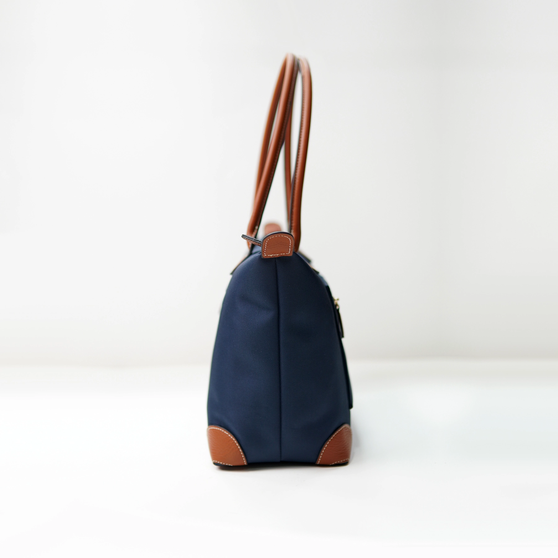Side-view handbag sample with handles for private label handbag production review