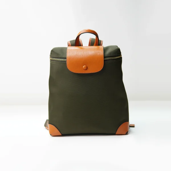 Canvas backpack with leather trim documented for custom handbag manufacturing