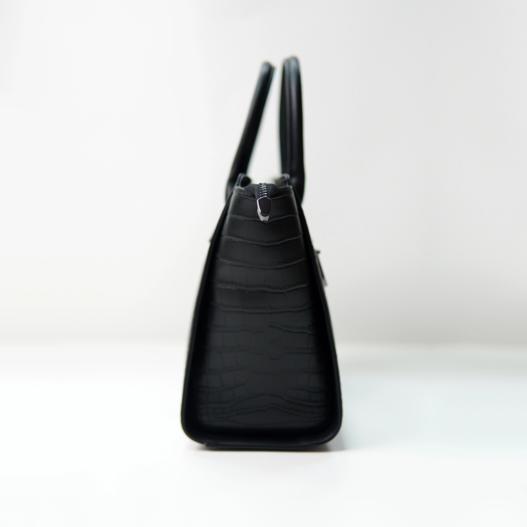 Black embossed handbag side profile for custom handbag manufacturing reference