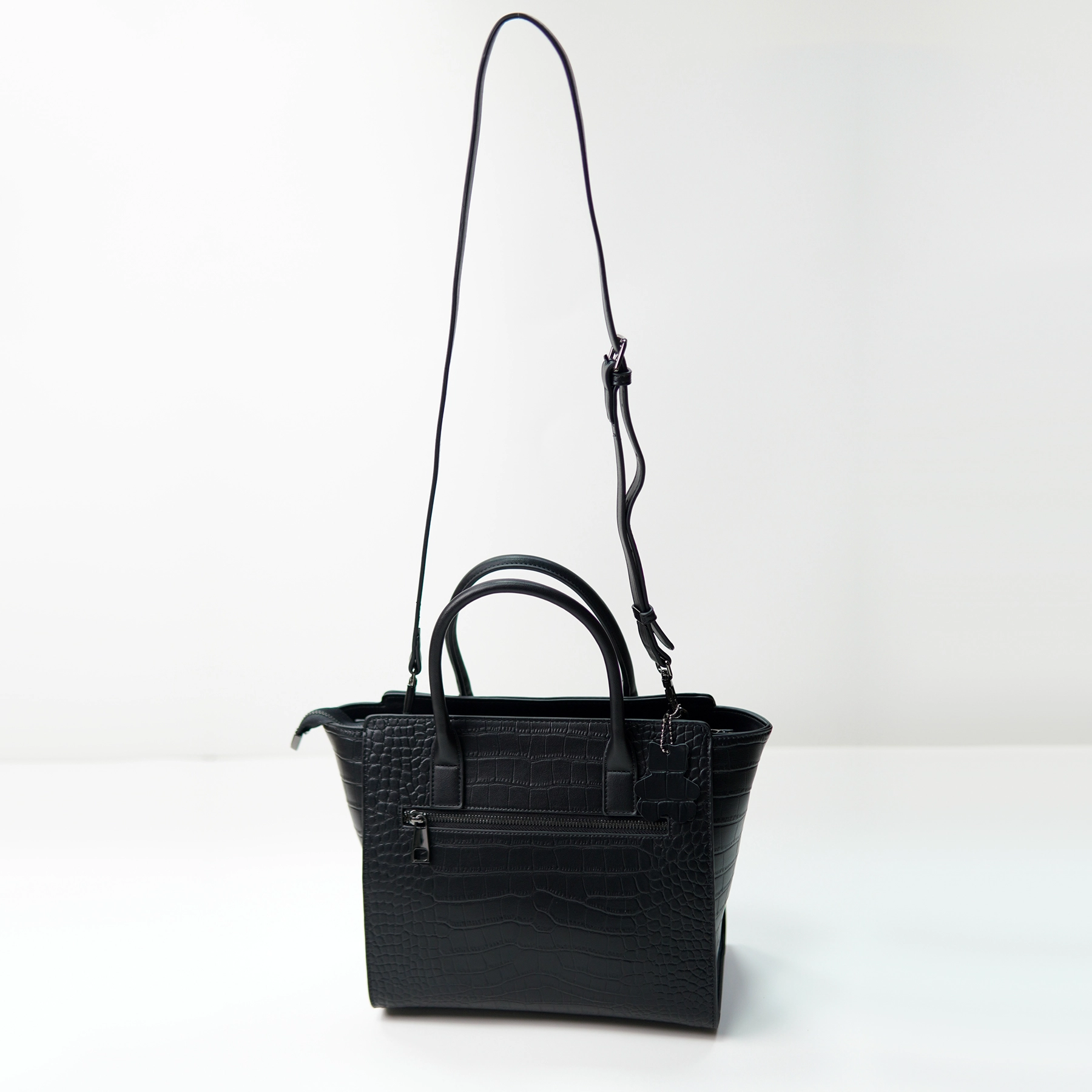 Black crocodile-embossed handbag sample for private label handbag production review