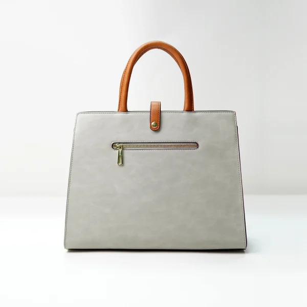 Structured tote bag sample for custom handbag manufacturing with zipper pocket
