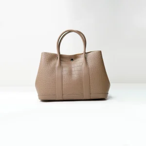 Embossed leather tote sample for custom handbag manufacturing specification review