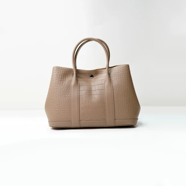 Embossed leather tote sample for custom handbag manufacturing specification review