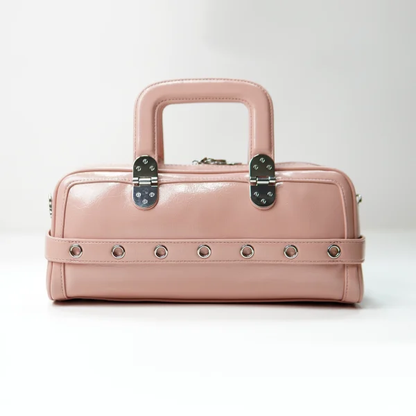 Pink structured handbag sample with rivet strap for custom handbag manufacturing