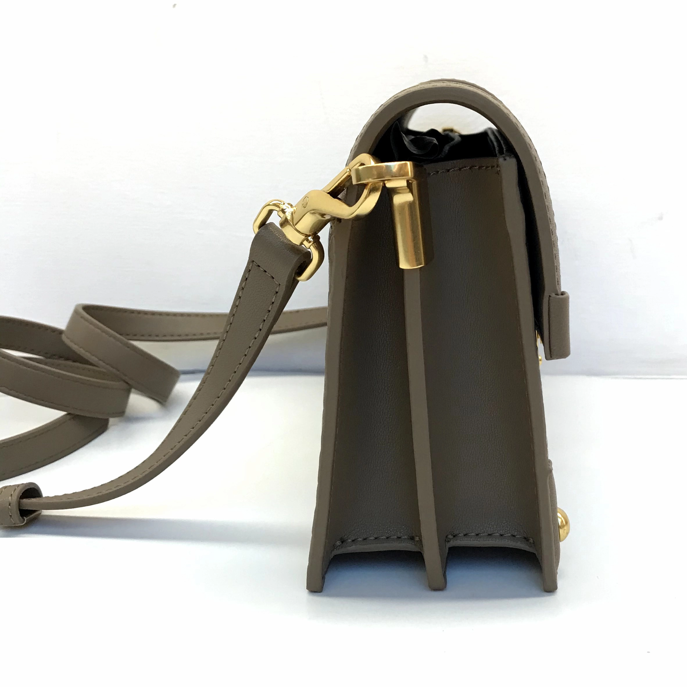 Side view of handbag hardware attachment for custom handbag manufacturing review
