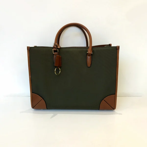 Structured tote bag sample for custom handbag manufacturing with leather trim