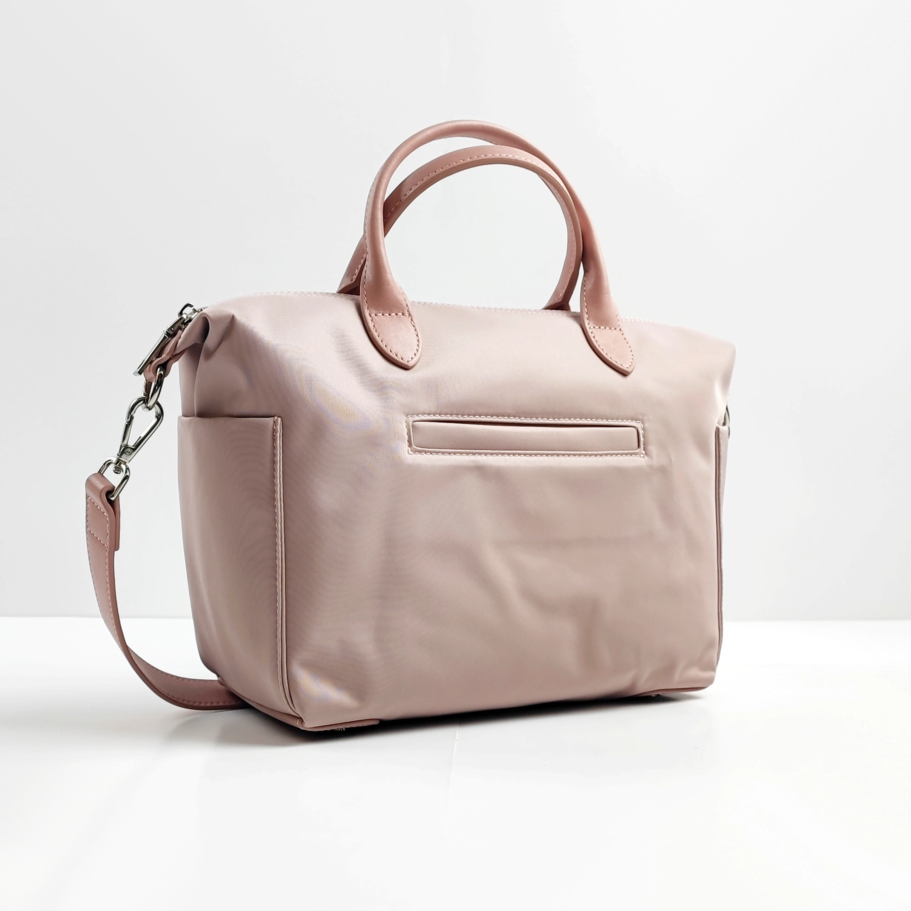Pink handbag sample with handles and strap for custom handbag manufacturing review