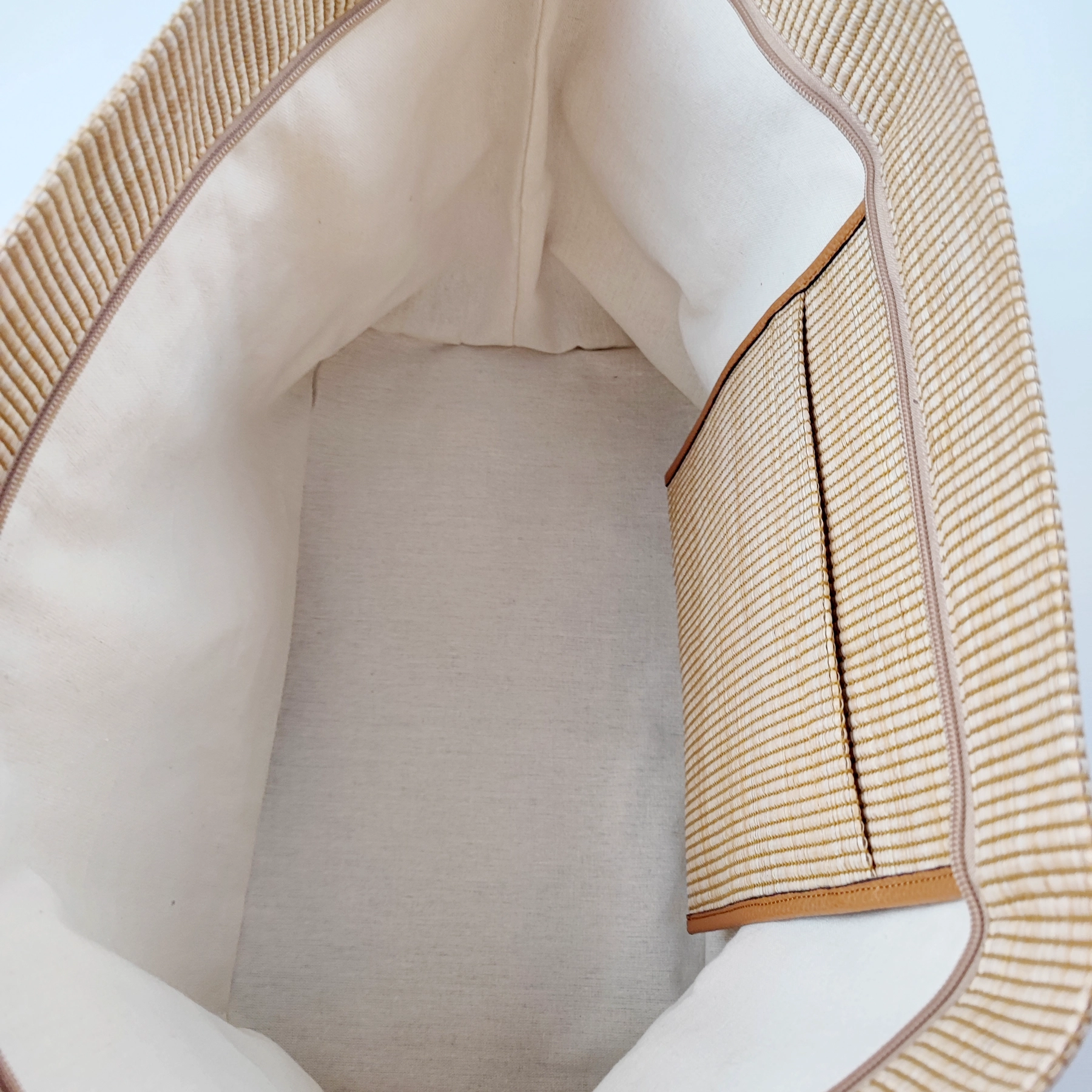 Interior lining and woven panels documented for custom handbag manufacturing review