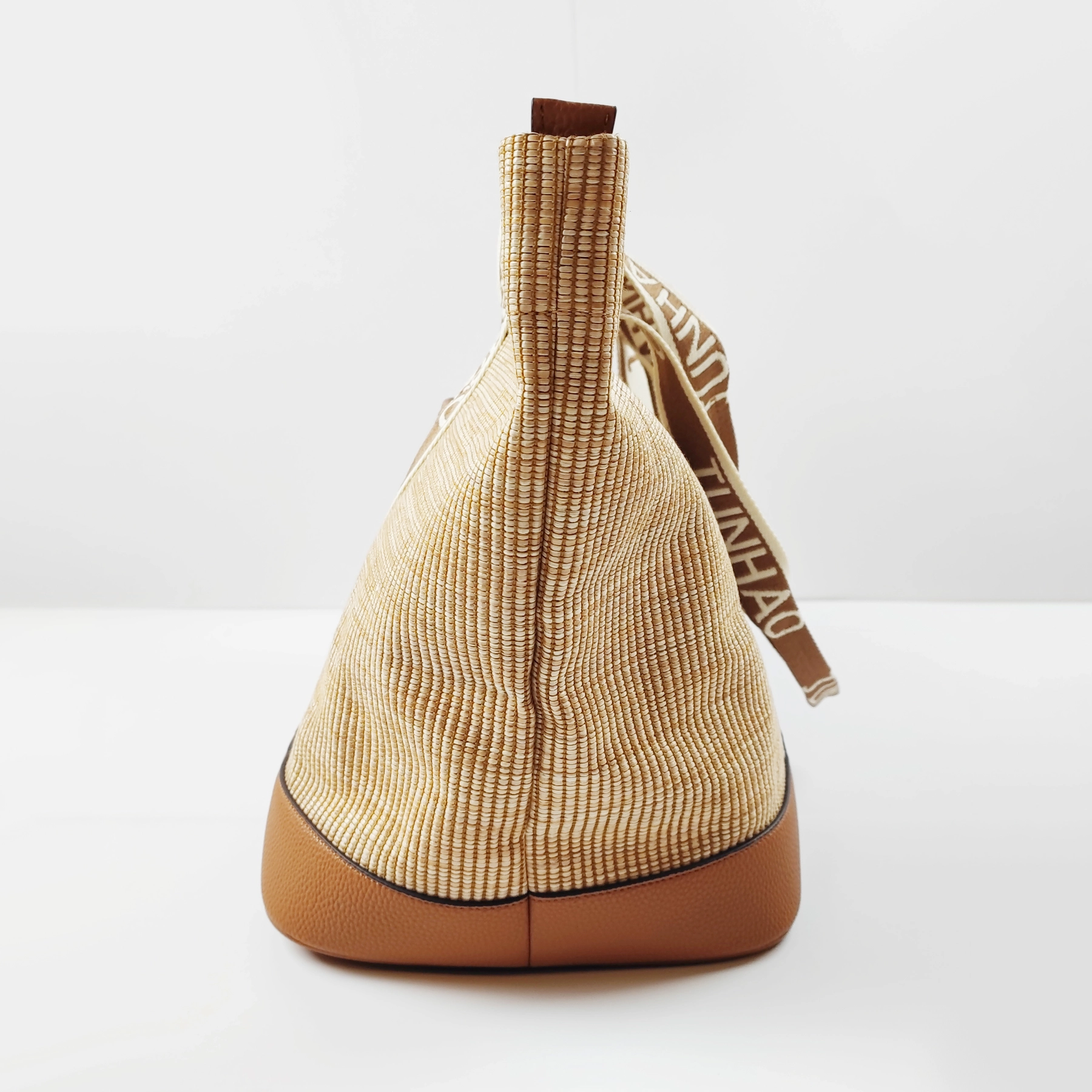 Woven bucket bag side profile for custom handbag manufacturing review