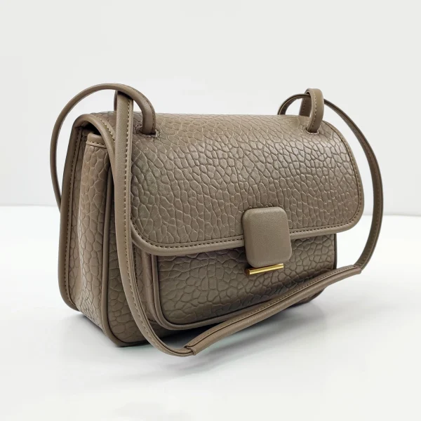 Embossed leather shoulder bag sample for custom handbag manufacturing review