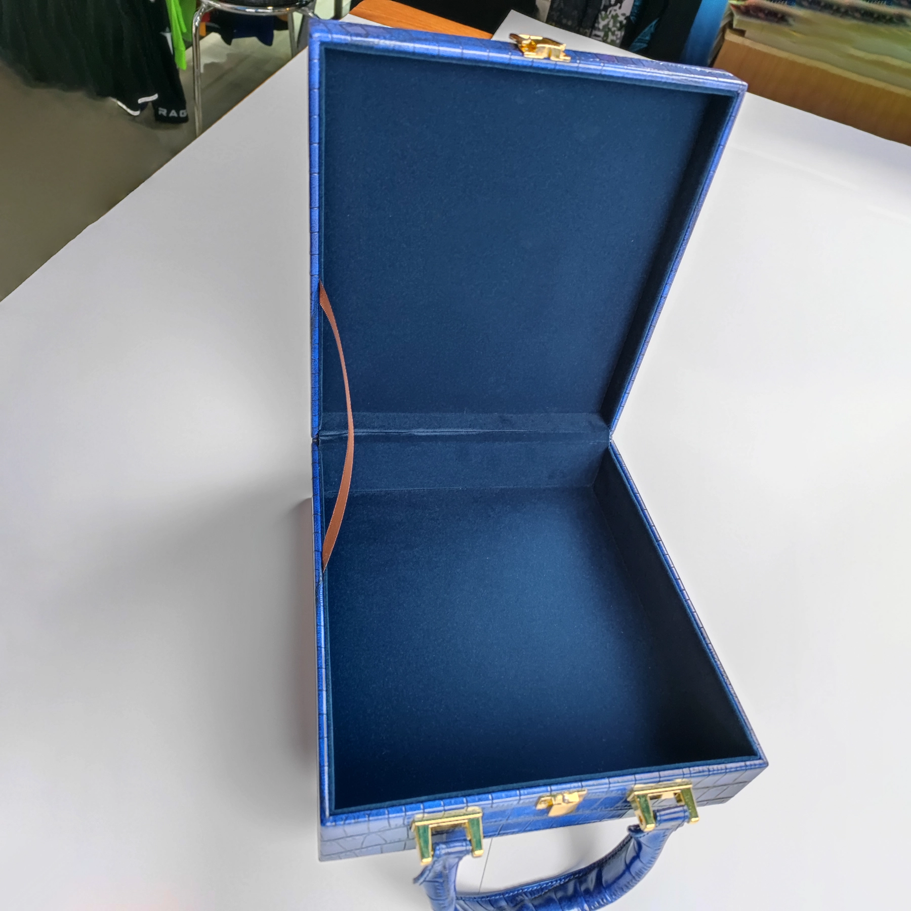 Open structured handbag sample showing lined interior for custom handbag manufacturing review
