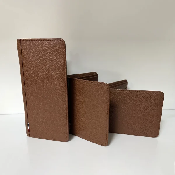 Brown pebbled leather wallets displayed for custom handbag manufacturing reference