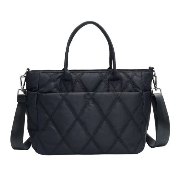 Quilted black tote sample for custom handbag manufacturing with detachable shoulder strap