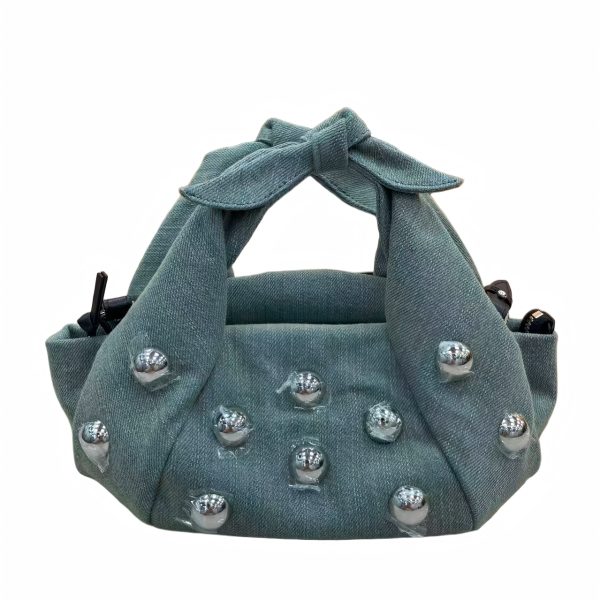 Denim-textured handbag sample with metal studs for private label handbag production