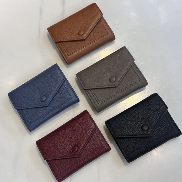 Pebbled leather wallet samples arranged for custom handbag manufacturing review