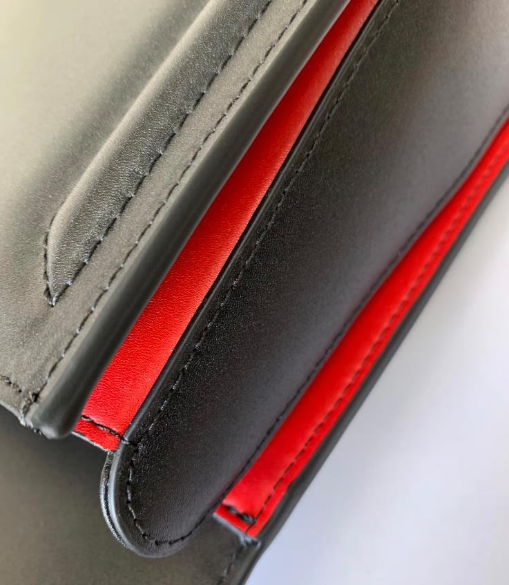 Finished Leather Edge Paint Detail Black leather bag with clean edge finishing and red contrasting leather detail