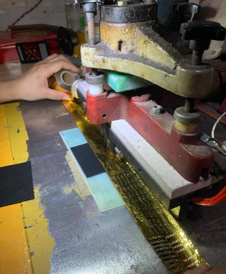 Gold foil hot stamping process for a custom leather bag logo