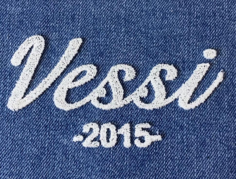 White 3D toothbrush embroidery logo on blue denim fabric